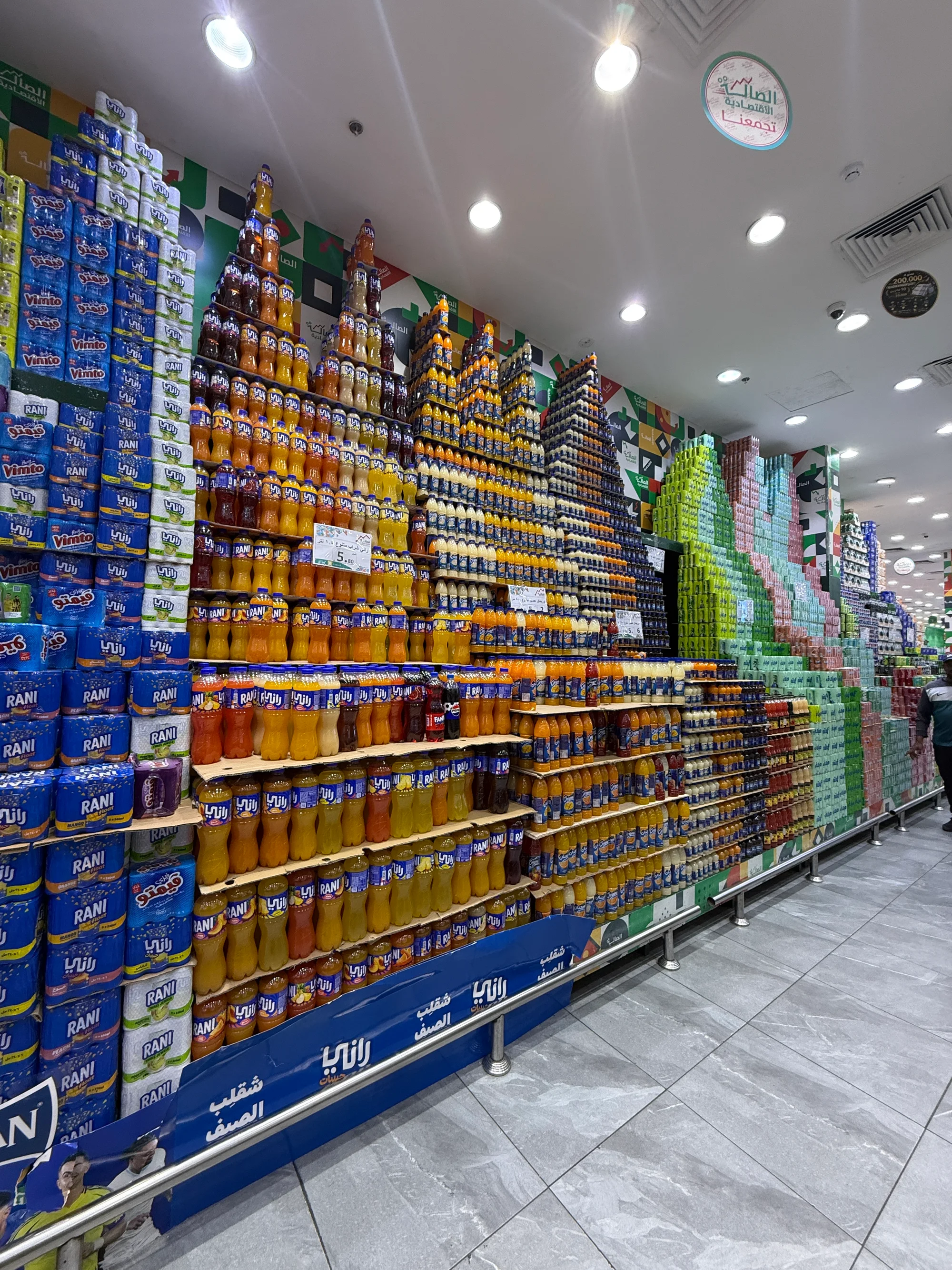 Promotional beverage tower display maintained by a merchandising team